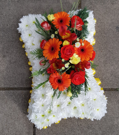 Funeral Pillow - A beautiful funeral tribute featuring coral and red blooms, thoughtfully arranged to symbolize love, remembrance, and the cherished memories that remain forever in our hearts.