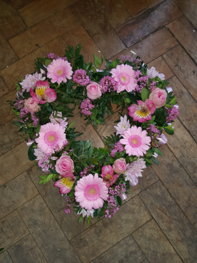 Pink Open Heart - This elegant open heart arrangement features a collection of pink blooms, creating a touching symbol of affection, remembrance, and eternal love. A fitting tribute to celebrate a cherished life and honour precious memories.