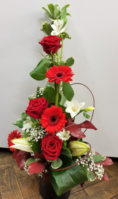 Ruby - A striking contemporary arrangement in rich red and crisp white tones, beautifully designed with height and lush greenery for an elegant finish.