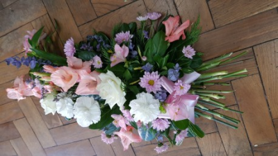 Pastel Sheaf - A graceful tied sheaf arranged in soft pink, white and purple tones, beautifully finished with fresh greenery for a heartfelt funeral tribute. 75cm